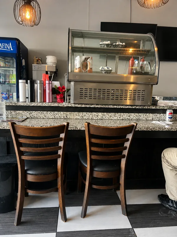 Counter seating and the checkerboard floor inside Nena’s