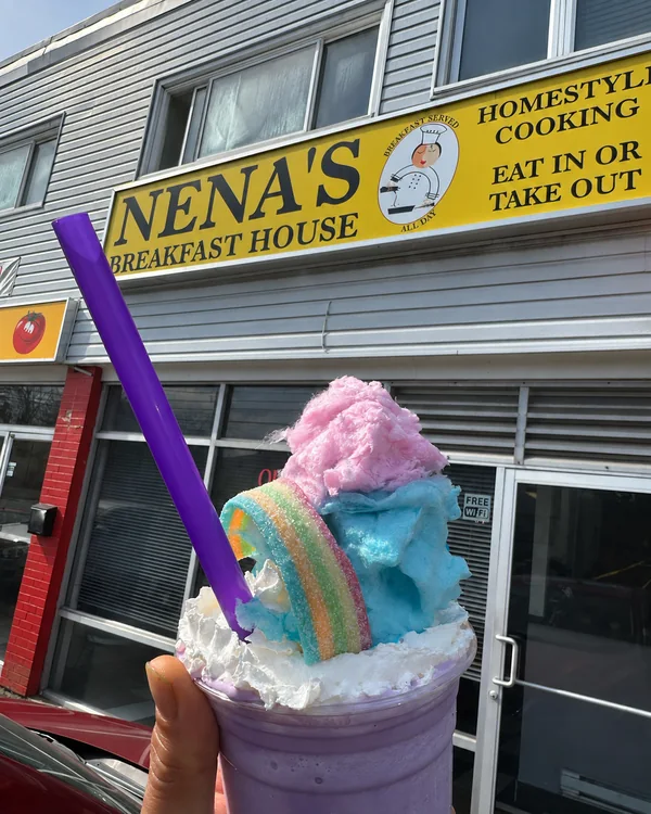 A colourful milkshake outside Nena’s yellow shop sign