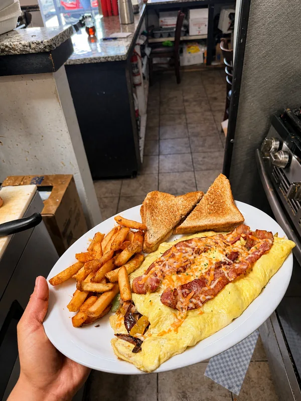 An omelette with toast and home fries