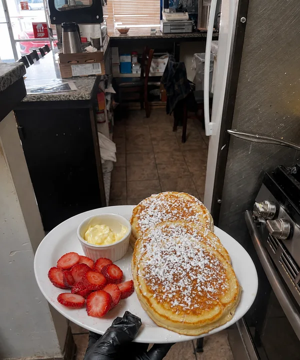 Pancakes with butter and fresh strawberries